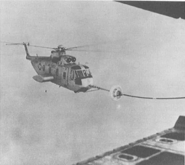 A photograph of a US "Jolly Green Giant" helicopter being aerial refueled over Vietnam.