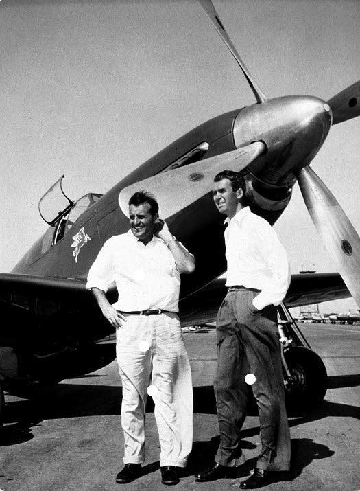 A photograph of Joe DeBona and Jimmy Stewart in front of the p-51C Thunderbird.