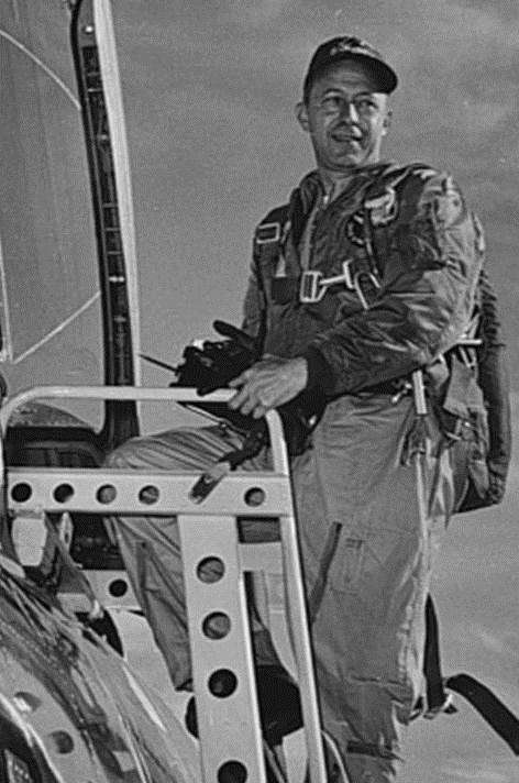 Major Adrian E. Drew, U.S. Air Force climbing into a Voodo Jet aircraft.