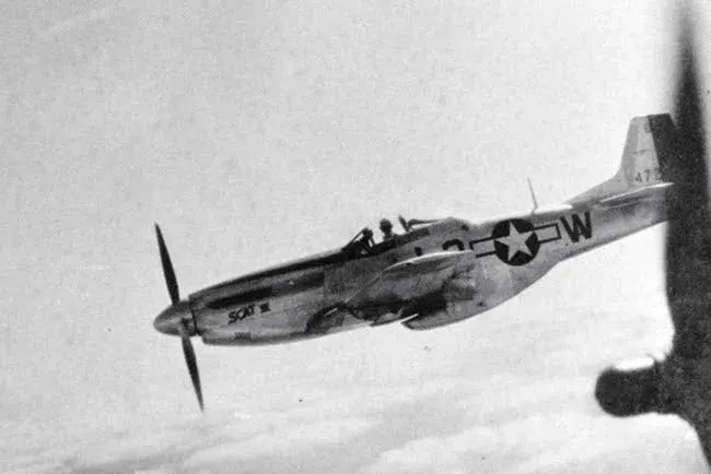 Robin Olds’ Mustang, SCAT VII escorts a B-17 Flying Fortress heavy bomber during WW II