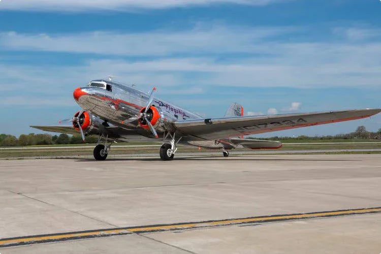 A photograph of one of the early DC-3 aircraft sitting on an airport ramp.