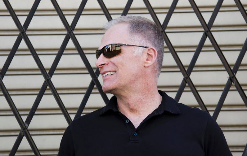 A photo of a man wearing a pair of Eagle Eyes PanoVu sunglasses with a black frame and TriLenium Polarized lenses.