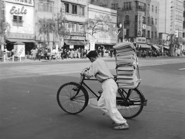 Newspaper boy in New York City in the 1950s getting ready to deliver his newspapers
