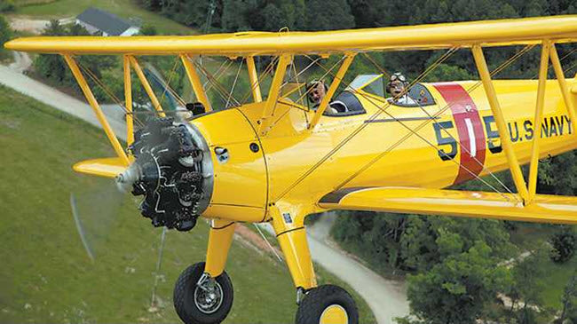 Veteran and author Pete Mecca in the front seat and pilot John Laughter in the back seat of his Stearman.