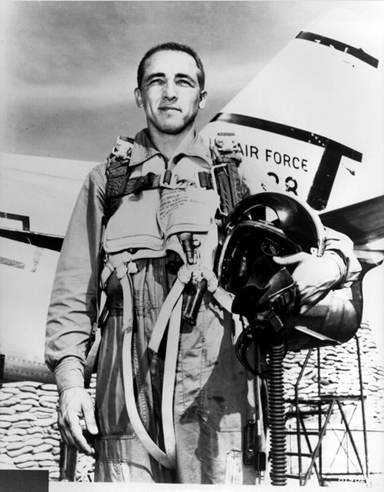 A photograph of Capt. James Robinson "Robby" Risner in front of a North American F-86 Sabre jet fighter.