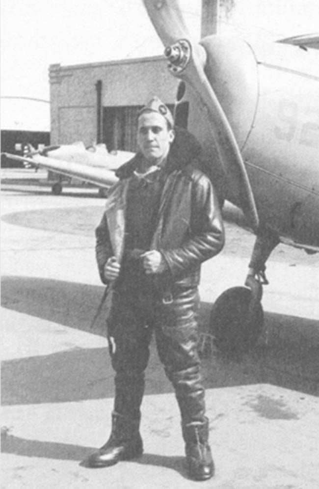 Christopher Lyman Magee in front of a Fairchild PT-19 at the Sparta School of Aeronautics hangar.