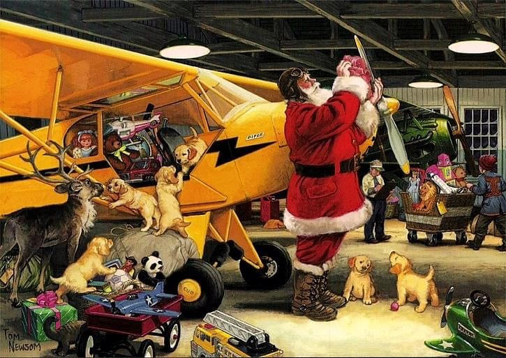 Image of Santa polishing the propeller on a Piper Cub as he gets ready to deliver Christmas toys to good (not naughty) children around the world