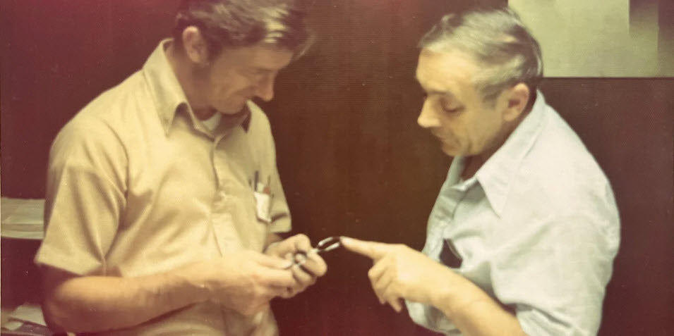 Jan Waszkiewicz and Stanley Zaleski discussing a frame which they are manufacturing at their plant in Randolph, MA