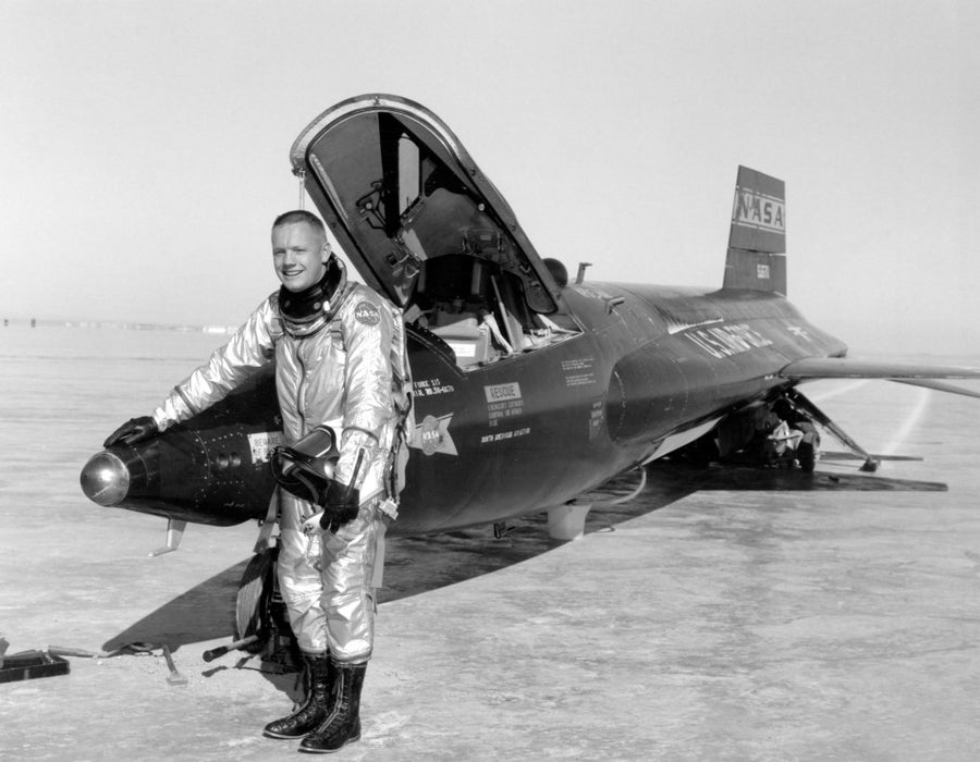 NASA Researcg Test Pilot Neil Armstrong with the first North American X-15, 56-6670, on Rogers Dry Lake after a flight in 1960. His right hand is resting on the ball nose sensor.