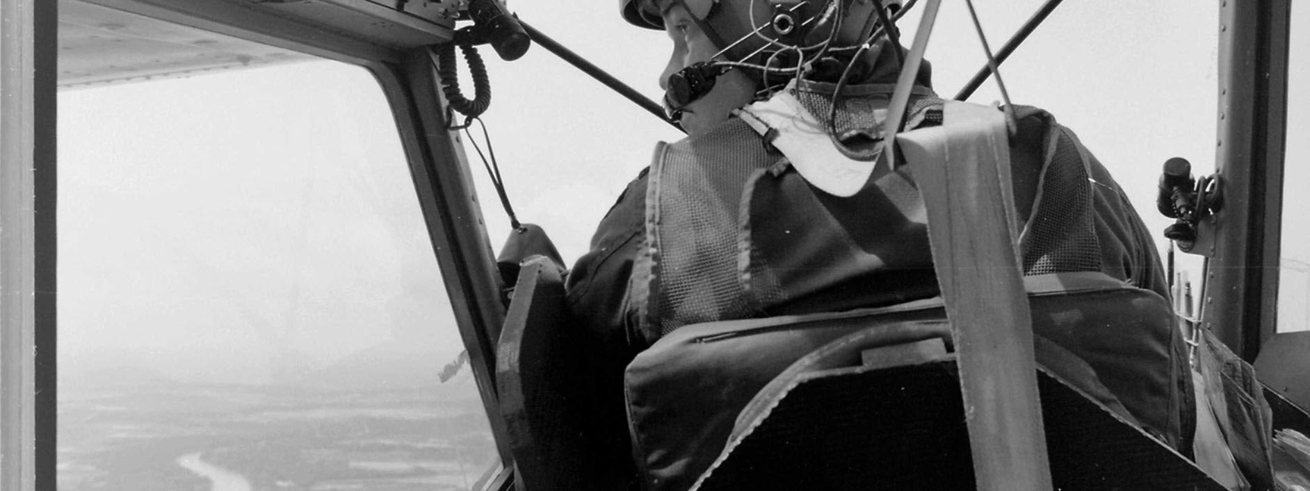 O-1 Bird Dog in flight with pilot searching for the enemy in Vietnam.