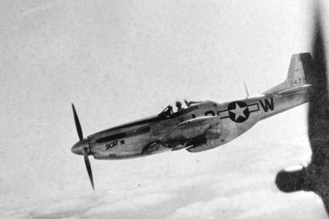 Robin Olds’ Mustang, SCAT VII  escorts a B-17 Flying Fortress heavy bomber during WW II