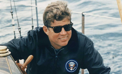 President John F. Kennedy wearing a pair of American Optical AO Eyewear Saratoga sunglasses while sailing.