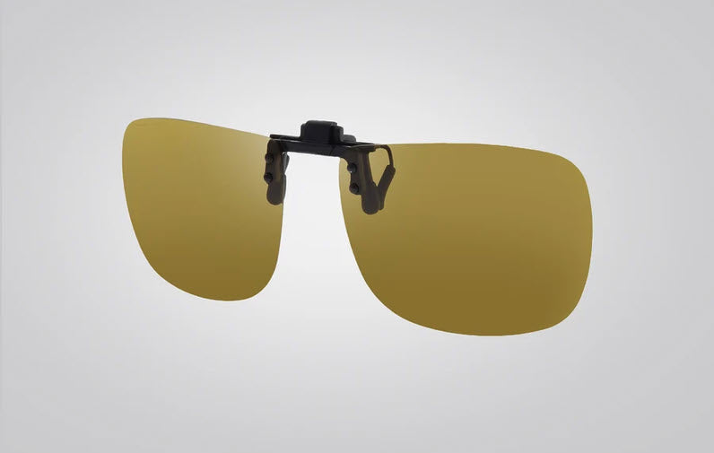 A pair of clip-on sunglasses with large yellow-tinted lenses and a black plastic mounting clip in the center, shown against a light gray gradient background.