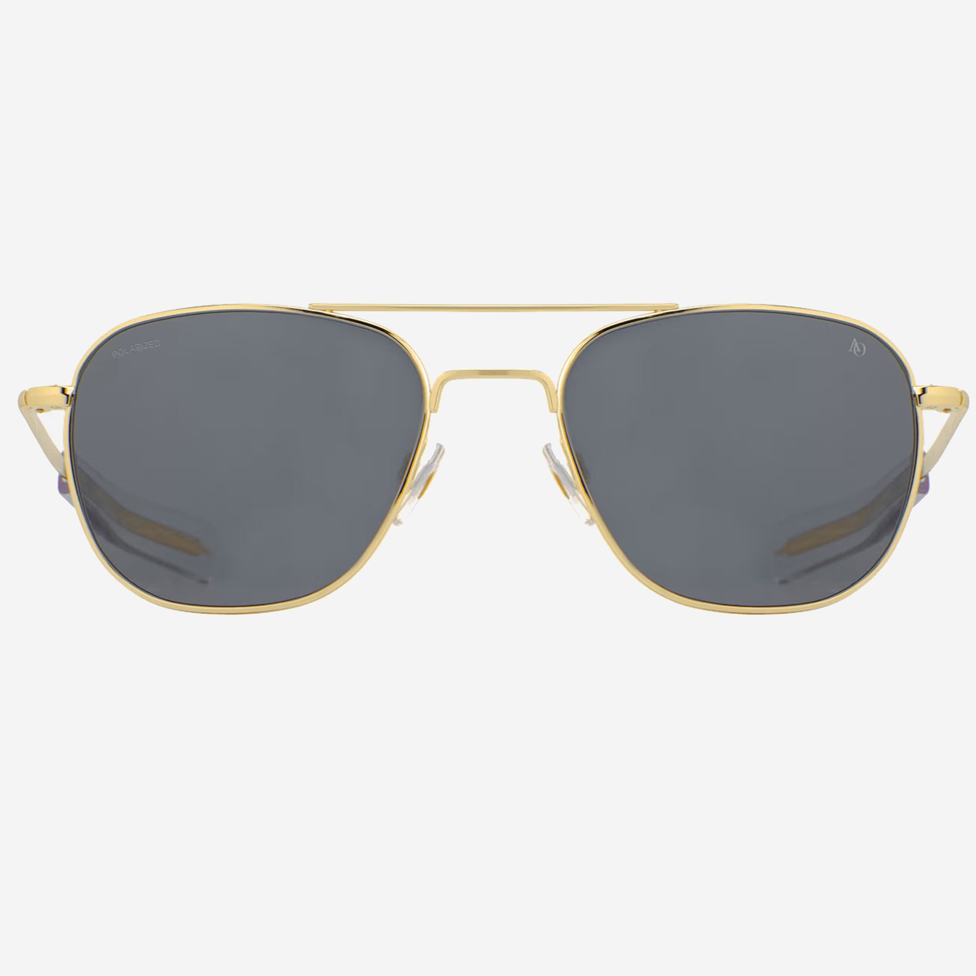 A pair AO Eyewear Original Pilot aviator sunglasses with a gold metal frame and dark gray lenses, shown from a front-facing perspective on a light gray background.