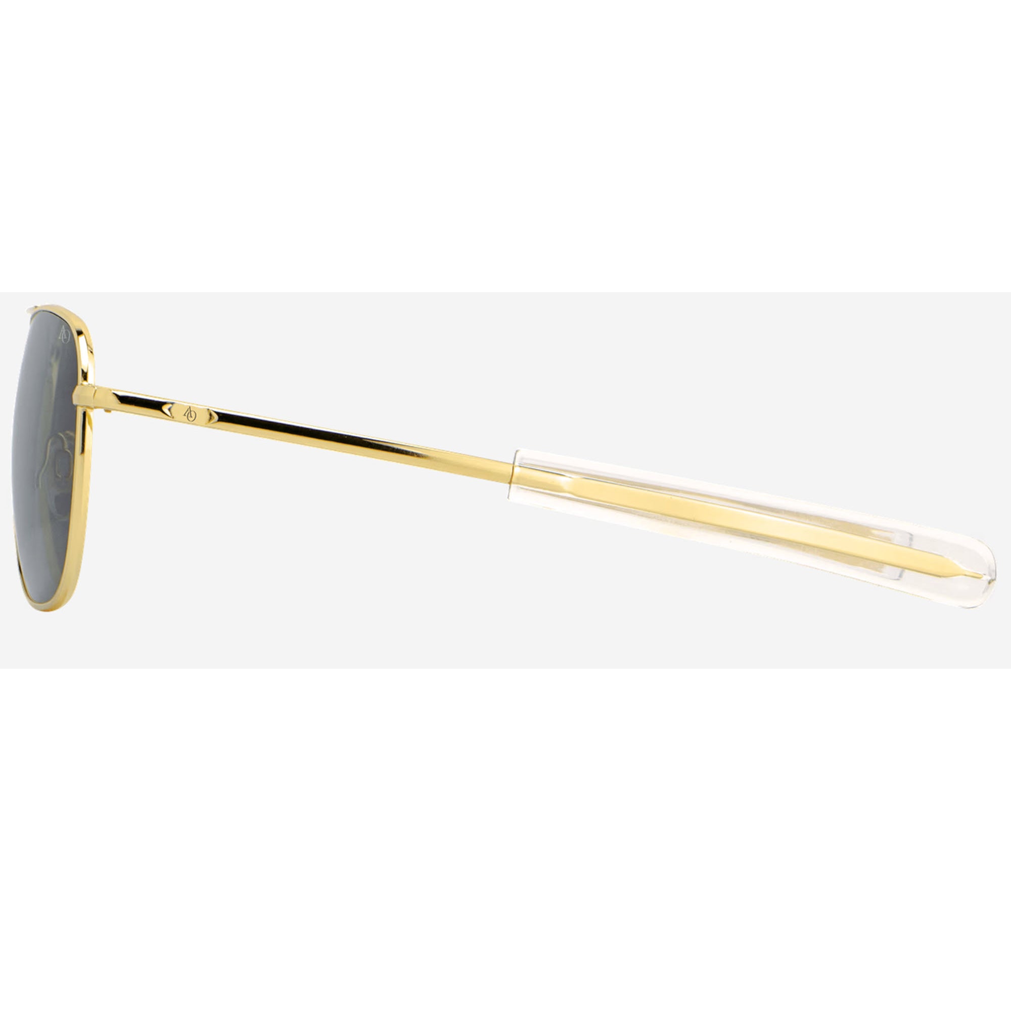 AO Original Pilot Aviator sunglasses with a gold metal frame, dark gray lenses, and a clear transparent temple arm, shown in profile against a light gray background.